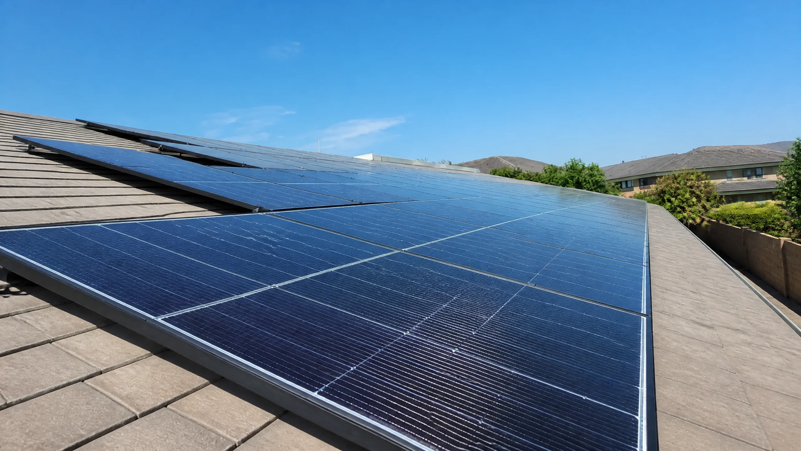 Installer fitting solar panels on mounting rails